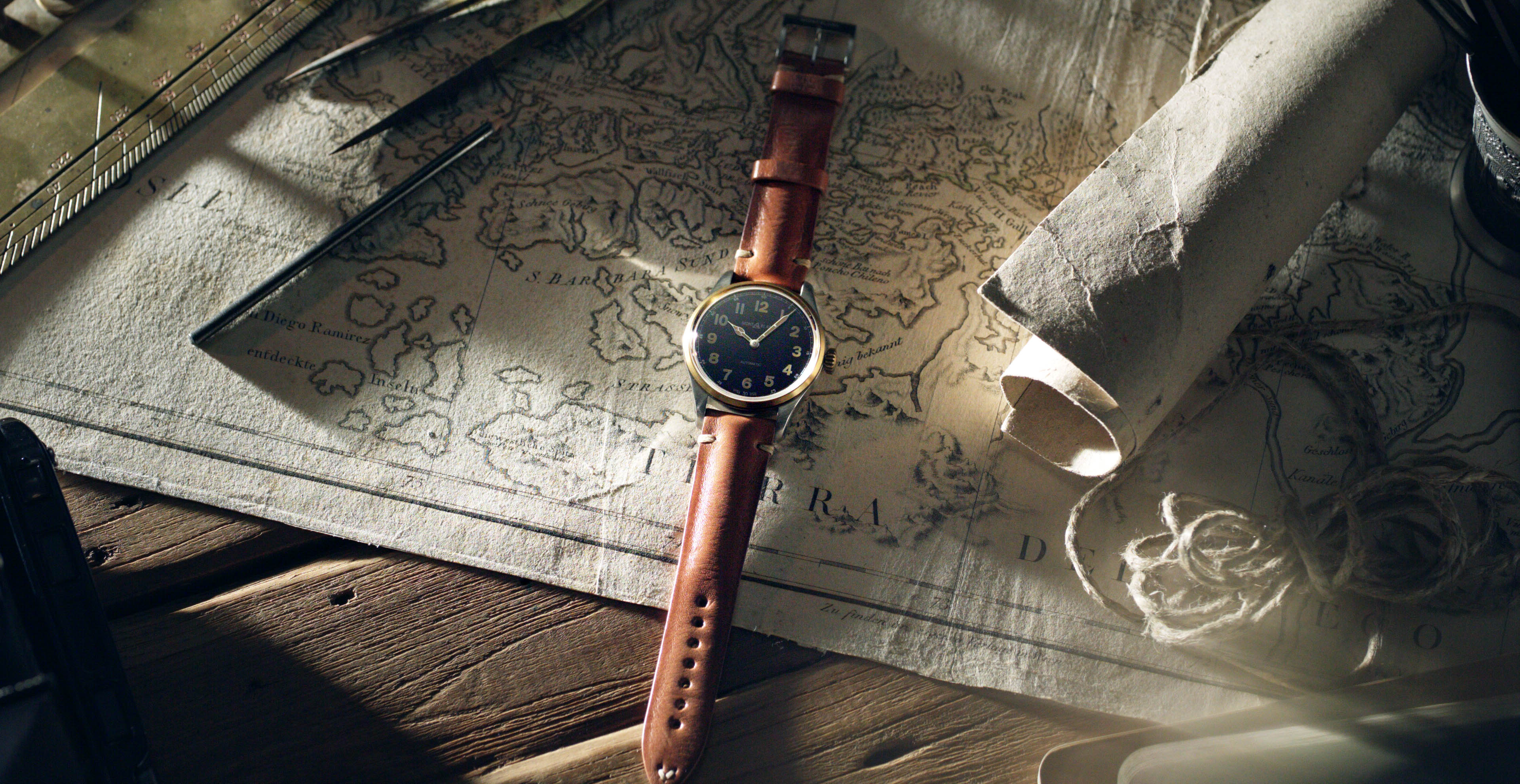 Brown watch on an old map